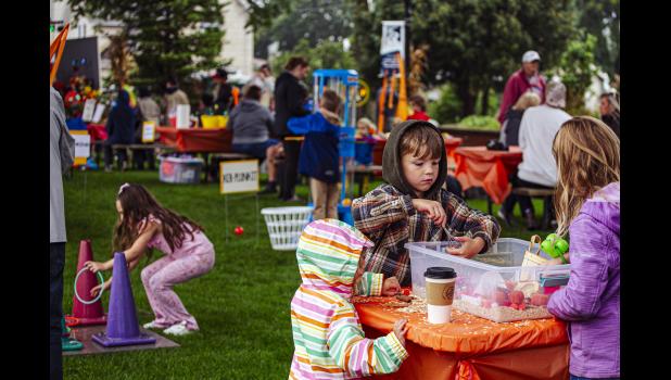 Kids manage to find fun all over Heritage Park despite the rain and dreary weather.
