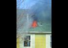 Flames were already tearing through the roof of the West Side Tavern Friday afternoon before firemen could get water onto the roof.