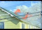 Flames shoot through the roof of the West Side Tavern Friday afternoon as Wabasha firefighters begin to arrive at the scene.