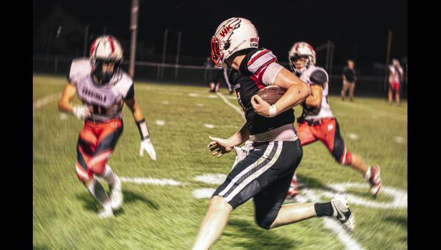 Bryar Ender, no. 4 Falcon Captain, receives and runs 40 yards as the clock runs out in the first half, eventually tackled by three Cardinals just a few yards short of the end zone. Photos by Sophie Horgan | Editor