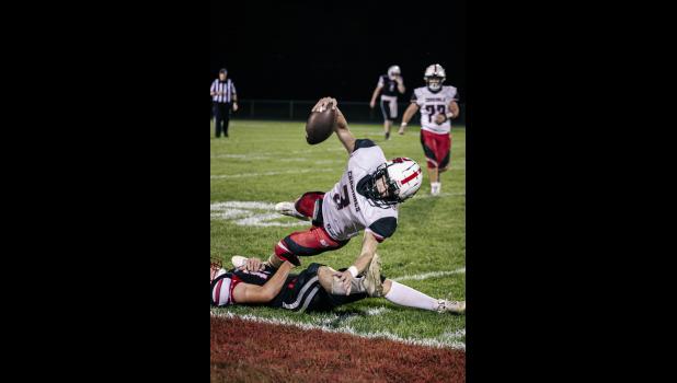 Cardinal quarterback, Hayden Dillon, gets taken down by Falcon quarterback, Kevin Wiebusch.