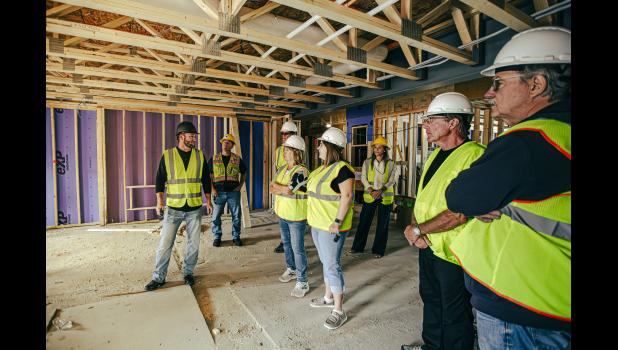 Andy Baartman (far left) gives a brief introduction as they stand in the main entrance of the building.