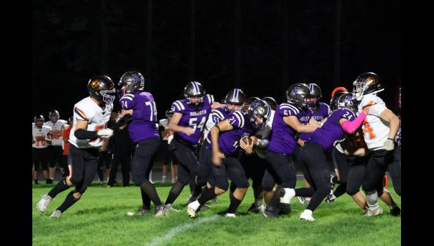 Augusta's Nate Atchinson with the ball being helped by lineman to gain a few yards against Whitehall at Centennial Field. Photo by Jen Lienhardt