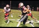 Bryar Ender, no. 4 Falcon Captain, receives and runs 40 yards as the clock runs out in the first half, eventually tackled by three Cardinals just a few yards short of the end zone.  Photos by Sophie Horgan | Editor